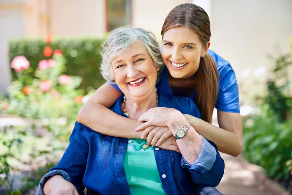 Woman embracing an elderly woman , providing health support